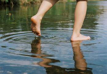 young woman walking in the river