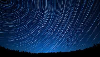 A long-exposure photograph captures star trails arcing beautifully across the night sky above a silhouetted forest, illustrating the Earth's rotation.