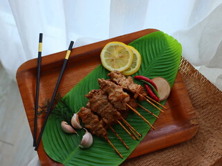 Moo Ping (Thai grilled pork skewers) — a beloved Thai street food made from marinated pork...