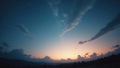 Fototapeta premium Serene sunset over mountains with stars and clouds