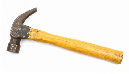 Close-up of a vintage hammer with a wooden handle, perfect for construction, carpentry, and DIY projects.