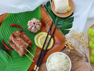 Grilled fermented pork sausage (Naem Yang) — a popular Thai snack with tangy, smoky flavors, grilled to perfection for a crispy exterior and chewy inside.