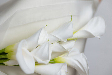 Close-Up of Calla Lily Bouquet on Wedding Dress