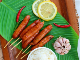 Grilled sausage — a popular street food in Thailand and many cultures worldwide. Juicy and smoky, these sausages are cooked over charcoal or an open flame until golden brown. Often served with sticky 