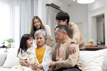 Happy Asian multi generational family spending quality time at home, grandparents with children and...