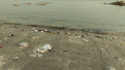 trash, plastic cups and plastic bags at the beach.environmental problem concept and healing the world	