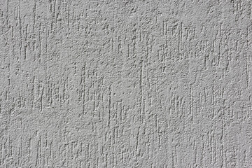 Rugged white concrete wall close-up abstract textured background