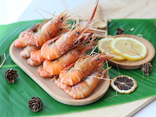Grilled river prawns — a premium Thai seafood dish featuring large freshwater prawns grilled over charcoal until the shells are slightly charred and the head fat turns golden. Served with spicy Thai s