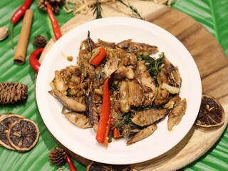 Stir-fried mackerel with Thai basil — a flavorful Thai home-style dish made with fried short mackerel (Pla Too), stir-fried with garlic, chili, and fresh holy basil leaves. Rich in aroma and spicy fla
