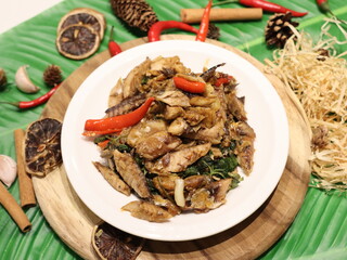 Stir-fried mackerel with Thai basil — a flavorful Thai home-style dish made with fried short mackerel (Pla Too), stir-fried with garlic, chili, and fresh holy basil leaves. Rich in aroma and spicy fla
