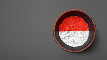 Closeup view of the red and white colors of the Indonesian national flag with a black wall background. Celebrate Indonesia Independence Day. Concept of Kemerdekaan Indonesia