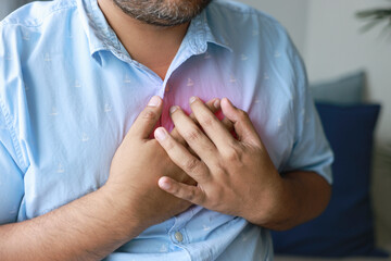 A man injured his left breast. Causes of pain include Heart disease, Pleurisy, Costochondritis, Pectoral muscle inflammation, and Acid reflux disease. Healthcare medical concept.