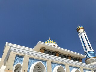 The view of the blue sky with the appearance of minimalist building architecture, there are towers and domes that look like a place of worship, abstract photography, soft, design, wallpaper. © ArtWorks