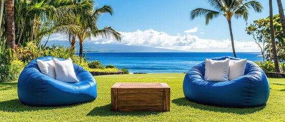 Fototapeta premium Two Blue Beanbag Chairs and Wooden Table Facing the Ocean on Grass Lawn