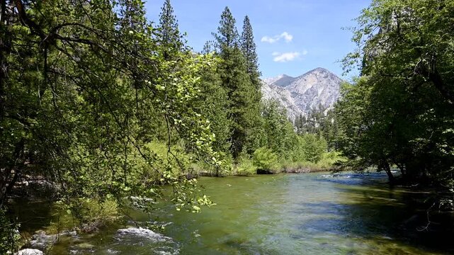 The South Fork of the Kings River flows through Kings Canyon National Park in Northern California as mountains of the Sequoia and Kings Canyon Wilderness rise in the distance.