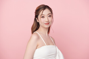 A beautiful young Asian woman with clean, fresh skin against a pink background. Skincare, facial treatment, cosmetology, beauty, and spa. An elegant portrait of an Asian woman.