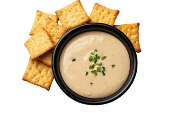 Cracker and Dip Culinary Delight: A tempting assortment of square crackers encircling a black bowl filled with a creamy dip. A culinary still life showcasing delicious appetizer.