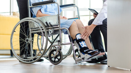 Close up asian doctor physiotherapy check splint leg support to senior old woman patient assisted...