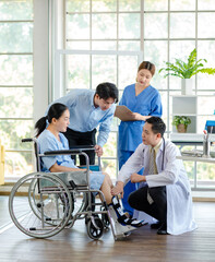 Asian doctor physiotherapy check splint leg support to senior old woman patient assisted by caregiver and nurse medical orthopedic trauma treatment team providing rehabilitation in a healthcare clinic