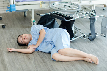 Asian female patient suffering from heart attack accidental fall down from chair lies unconscious...