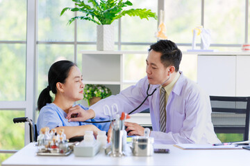 Asian male doctor in white coat examining senior female patient listening breathing with stethoscope consulting professional support healthcare checkup, insurance treatment wellness in hospital clinic