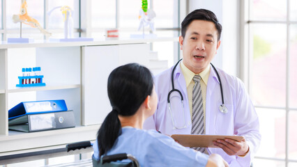 Asian male doctor in white coat with stethoscope, consulting explain medications to senior female...