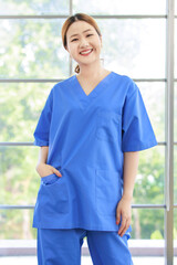Portrait asian happy cheerful woman caregiver nurse workers for medical career growth with pride smiling professional female healthcare confidence look at camera in hospital treatment wellness clinic.