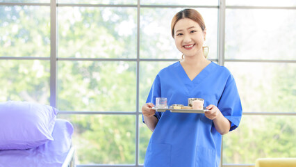 Portrait asian happy cheerful woman caregiver nurse career growth with pride smiling professional holding tray of medicine healthcare confidence look at camera in hospital treatment wellness clinic.