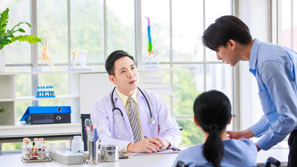 Asian professional doctor consulting senior old female patient with caregiver beside in bright medical office checkup insurance attentively reviews health details  care support examination healthcare