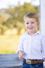 Portrait of happy little boy smiling on farm