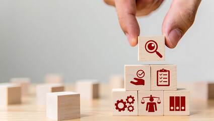 Hand placing wooden block with magnifying glass icon on stacked blocks wooden blocks checklist