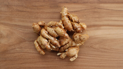 Top view of aromatic ginger on wooden surface