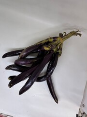 long slim purple eggplants isolated background