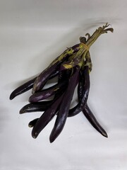 long slim purple eggplants isolated background
