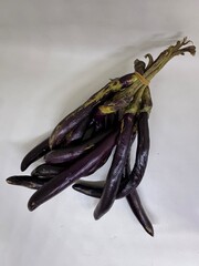 long slim purple eggplants isolated background