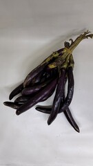 long slim purple eggplants isolated background