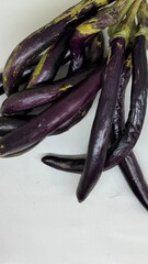 long slim purple eggplants isolated background