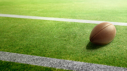 American football ball on the green field of an American football stadium. Concept of sport