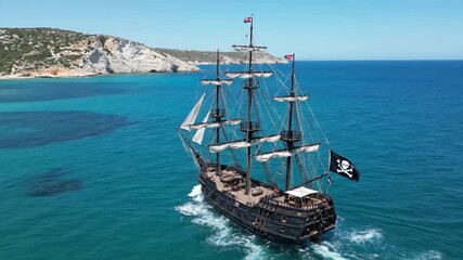 Aerial view of Pirate ship crew swimming in the sea, Turquoise Voyage Majestic Pirate Ship Sailing on Crystalline Waters.
