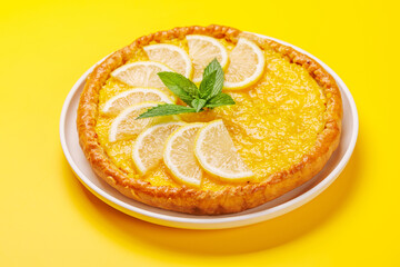 Delicious lemon tart with golden crust and smooth, glossy lemon filling