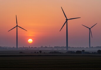 Radiant Sunrise Behind Silhouetted Wind Turbines in Misty Countryside Landscape