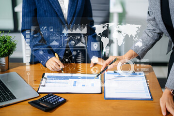 Two businesswomen review financial charts with digital data UI overlays in office. Concept of fintech, big data, global strategy