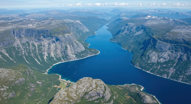 Magnificent aerial view of a serene blue fjord surrounded by majestic rocky mountains