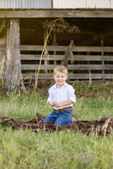 Portrait of happy little boy smiling on farm