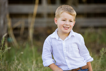 Portrait of happy little boy smiling on farm