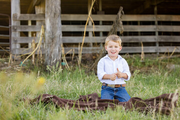Portrait of happy little boy smiling on farm © Caseyjadew