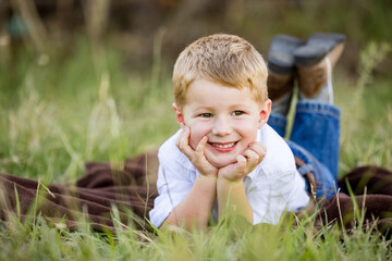Portrait of happy little boy smiling on farm © Caseyjadew