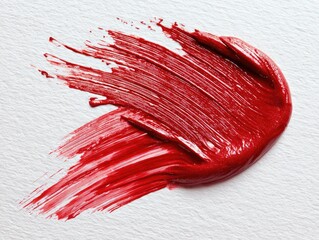 Bold red paint stroke on white paper