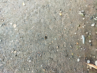 Gravel surface on country road. A dirt road in the countryside. Small stone road floor texture for background