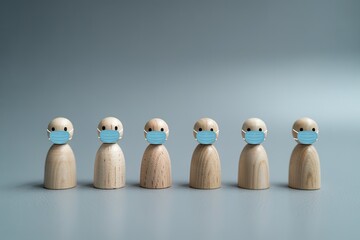Six wooden peg dolls wearing blue medical face masks standing in a line against a plain grey background